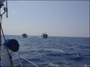 Here they come - what to think?  These turned out to be fishermen wanting cadge cigarettes and a bottle of water... but how do you know? © SW